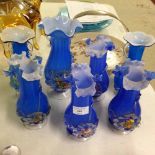 7 blue Murano glass vases with multicoloured flower design. 1 as found handle.