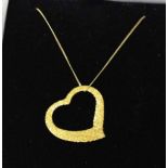 A 9ct gold floating heart pendant with glitter effect finish on a gold chain.