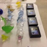 16 glass animals and 4 Stuart glass paperweights.