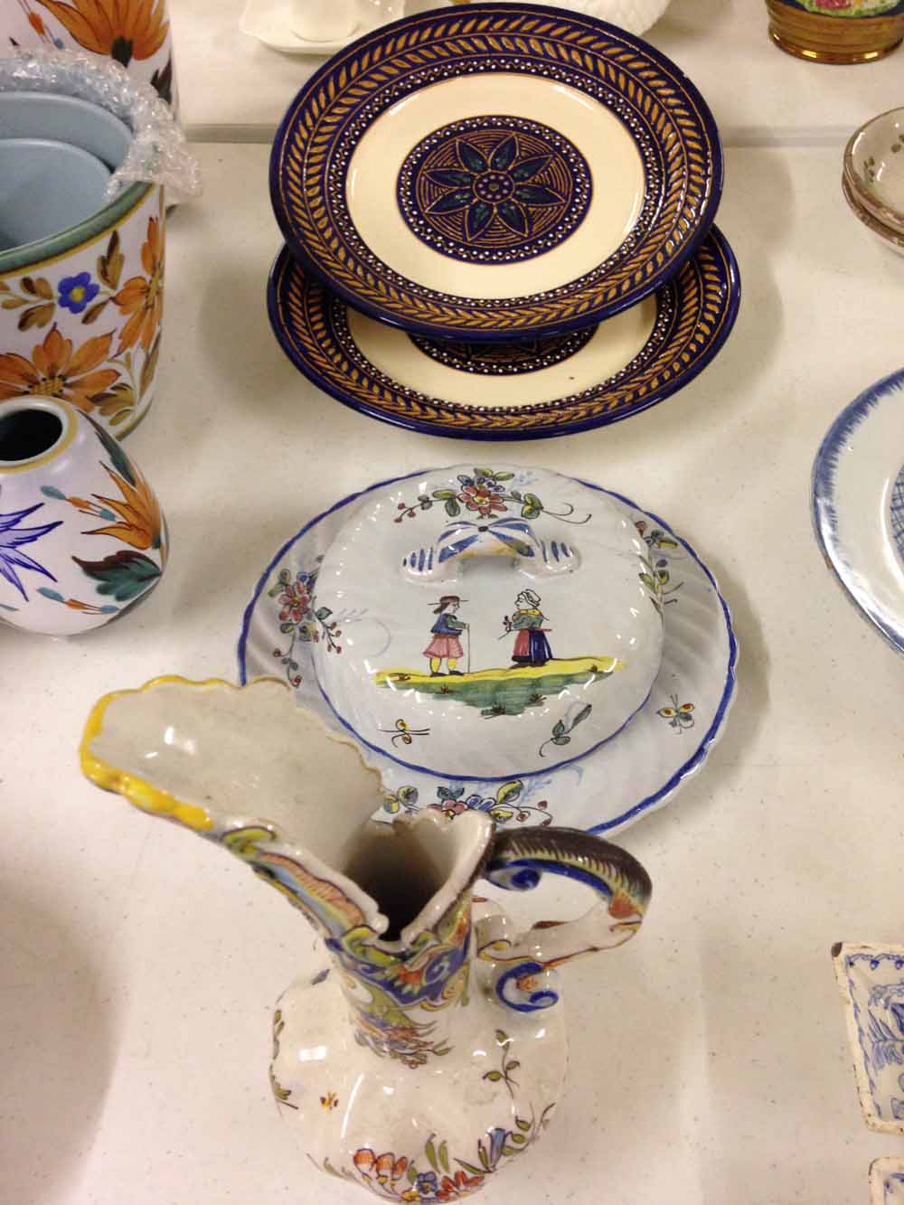 3 pieces of Quimper (2 unusual plates & a muffin dish) and a French faience jug