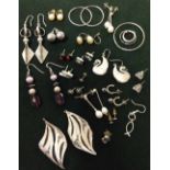 A tray of silver and white metal earrings.