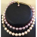 2 strings of heavy Michiko Pearls. One set lilac approx 30cm the other white approx 44cm.