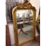 Large gilt mirror with rosebowl decoration to sides. 95 x 157cm.