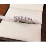 9ct white gold ladies half eternity ring set with 7 Cubic Zirconias. Size K½.