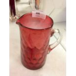 A Victorian hand blown Cranberry glass jug with pontil mark