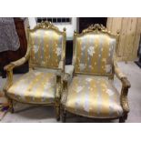 Pair french style giltwood chairs in gold upholstery.