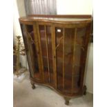 Walnut veneered art deco display cabinet with 'S' shaped front and ball & claw feet