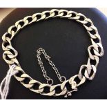 Heavy white metal (possibly continental silver) flat curb link bracelet with safety chain, approx