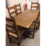 An Oak kitchen table with 6 beech chairs with rush seats. 168x76cm