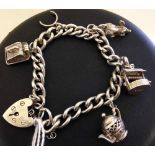 Heavy hallmarked silver charm bracelet with heart shaped padlock clasp, 4 silver charms & safety