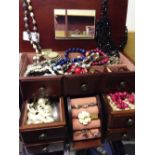 A wooden 'chest of drawers' jewellery box containing a quantity of costume jewellery