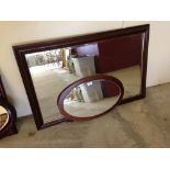 An oval C1970s mirror and a modern mahogany framed mirror