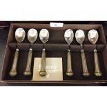 A boxed set of Denby Regency teaspoons with ceramic green handles.