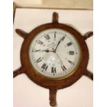 A modern ship's wheel wall clock