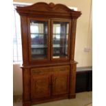 An oak sideboard/display cabinet with scroll top.