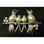 Decorative brooch featuring birds on a branch, set with faux pearls & diamante.