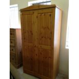 A 2 door pine wardrobe with curved top.