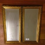 A pair of gilt framed rectangluar small mirrors. 42 x 20cm.