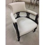 French style nursing chair on castors with cream upholstery.