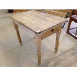 A small pine kitchen table with drawer to short side.
