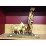 A wooden carving of a shepherd with a sheep & lamb. 40cm tall.