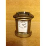 Miniature brass oval carriage clock.