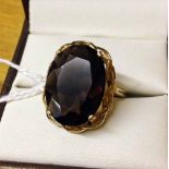 9ct gold ring set with very large oval smokey quartz stone in a pierced mount. Size R½.