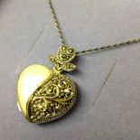 Mother of pearl & marcasite locket on a chain. As new, in box.