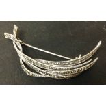 Silver and marcasite brooch with a four strand crossover design