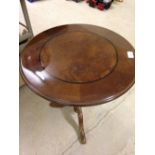 A modern walnut veneered round wine table.