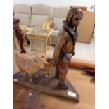 A wooden carving of a shepherd with a sheep & lamb. 40cm tall.