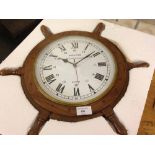 A modern ship's wheel wall clock