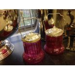 2 pink glass and silver plated biscuit barrels.