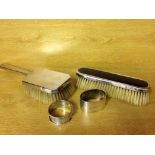 4 hallmarked silver items to include 2 napkin rings, a Mappin & Webb clothes brush - London 1904,