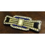 A silver Art Deco brooch with geometric design set in diamante on a blue, cream & black enamel