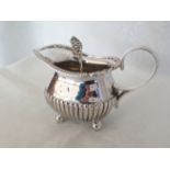 A silver sauce boat with ball feet, London 1899. Approx 153g with a continental silver sauce ladle.