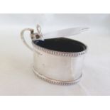 A silver mustard pot with hinged lid & blue glass liner, Birmingham 1912.