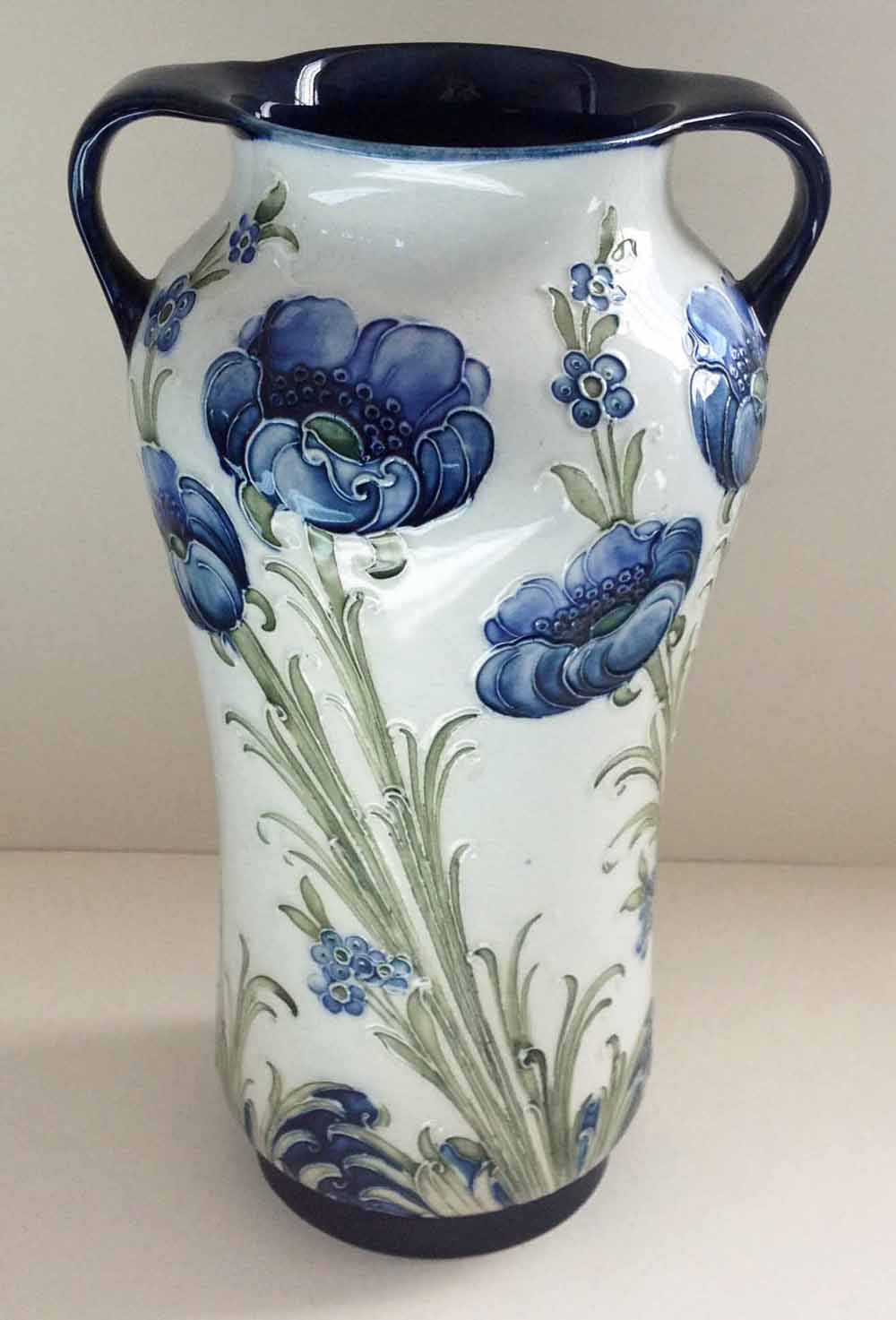 A William Moorcroft McIntyre two handled vase Florian ware Blue Poppy pattern. 24cm tall. We believe