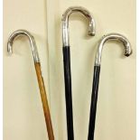 3 continental early 20th century walking sticks with continental silver handles.