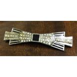 A silver Art Deco brooch with geometric shape laid out in diamante and black enamel. No hallmark (