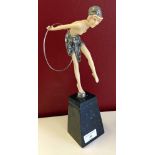 An art deco white metal and ivory coloured early plastic figure with hoop on marble base (damage