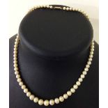 A vintage faux pearl necklace with 9ct gold clasp. Approx 16 inches.