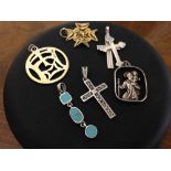 A collection of 6 pendants to include St. Christopher, crosses & an oriental symbol.