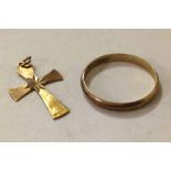 A 9ct gold cross with an 8ct 333 wedding band.