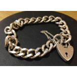 A heavy silver ladies link bracelet with heart padlock & safety chain. Approx weight 31g.