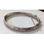 A childs HM silver hinged bracelet with engraved design to front. Birmingham 1917 makers mark C.H.