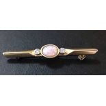 Ladies bar brooch with central multi-coloured cabouchon and 2 white stones.