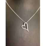 Silver open heart pendant set with crystals on a silver chain.
