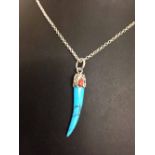 American Indian design pendant in silver with turquoise, on a silver chain.