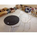 A 1930's bakelite topped circular garden table and 2 chairs